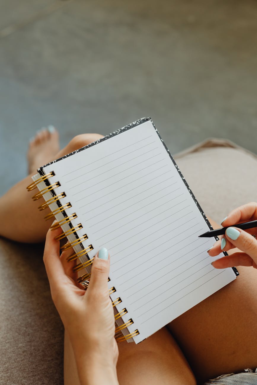 close up of holding a notebook and pen